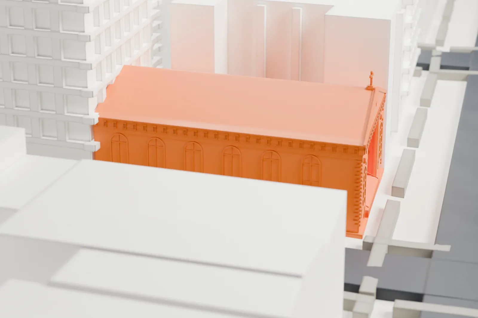 A white 3D print of the Church of St. Joseph in Greenwich Village, a low gabled church with a cross on its front and arched windows, between much taller buildings.