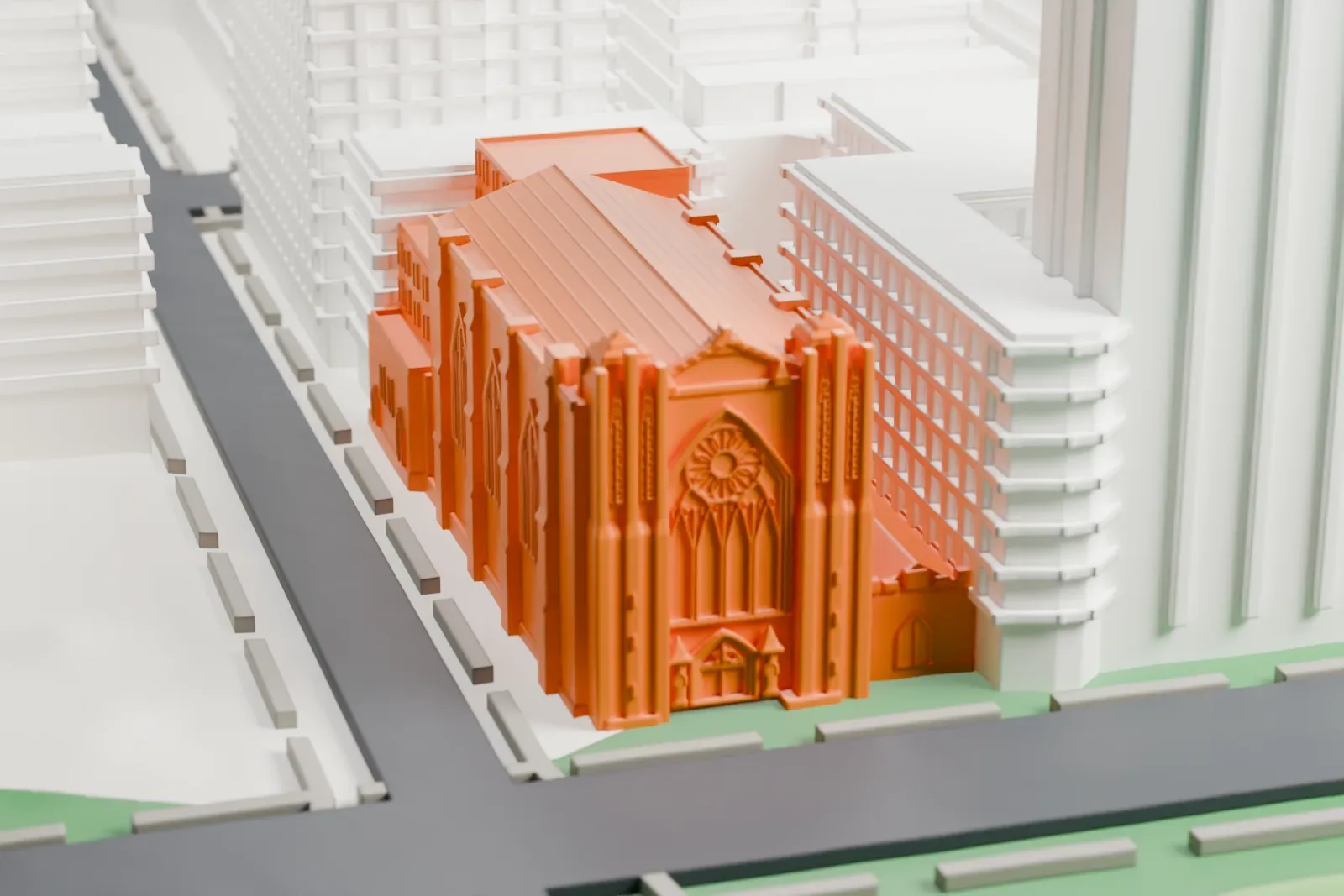 A white 3D print of the Church of the Heavenly Rest, a long church with pointed windows and a steep roof, beside a street and park with taller buildings around it.
