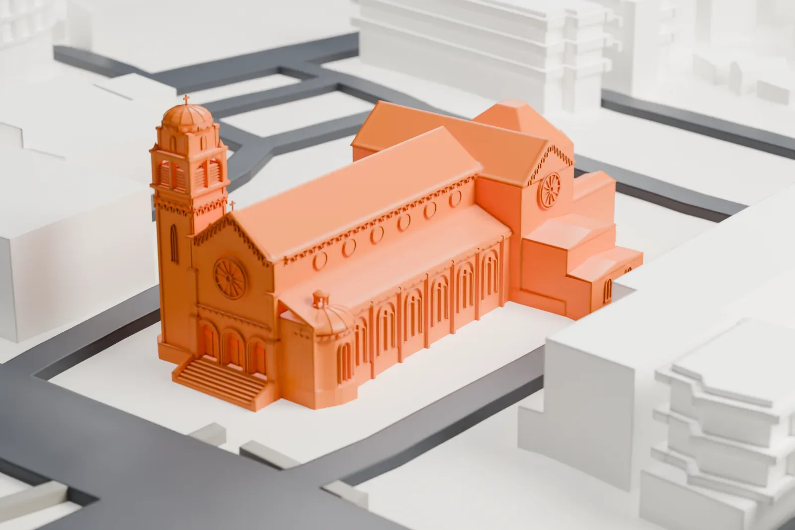 A white 3D print of the Church of the Holy Name, a long church with a gabled roof, a rounded apse and a domed corner tower, ringed by streets and larger buildings.