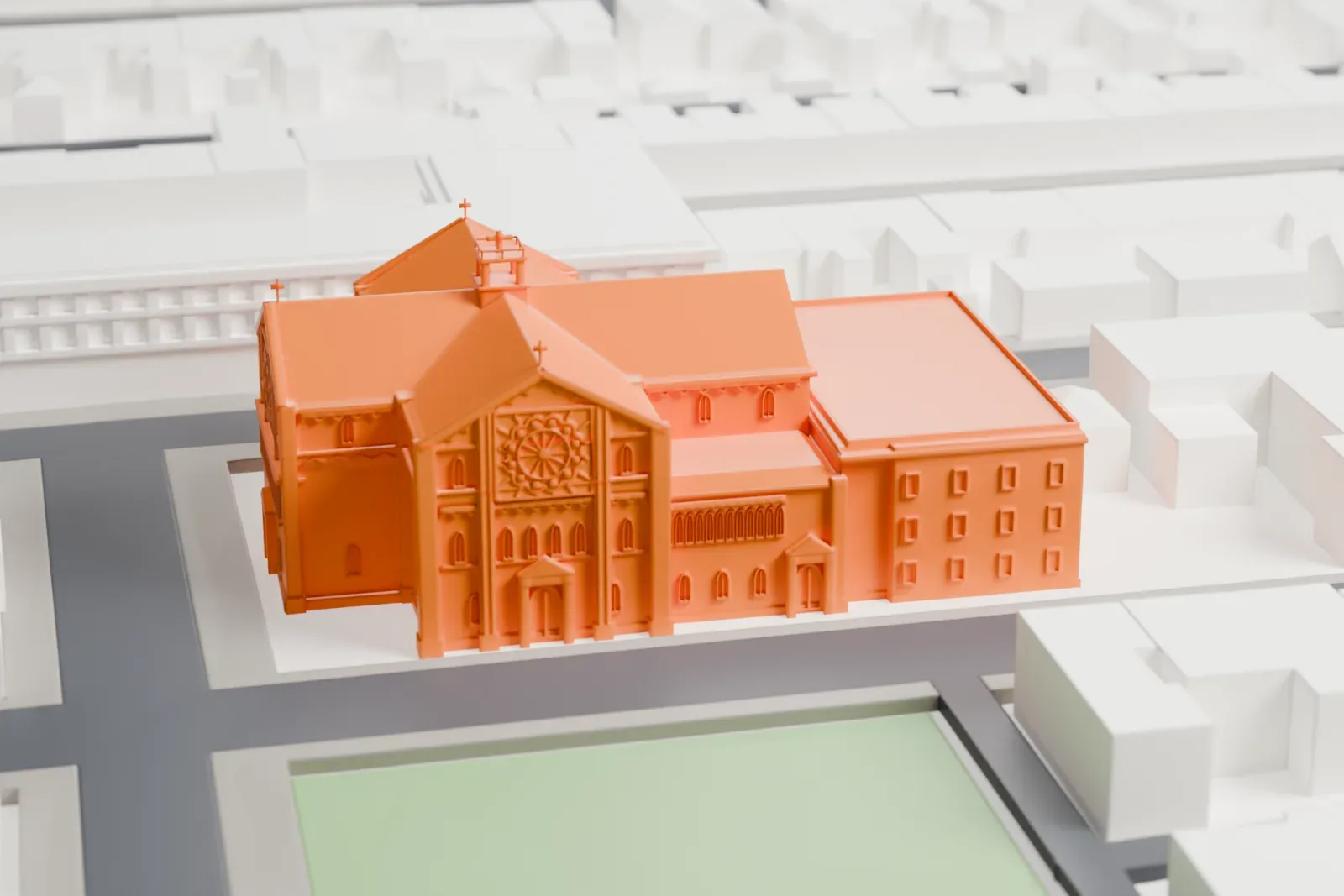 A white 3D print of the Church of the Madonna della Difesa among the surrounding streets and buildings.