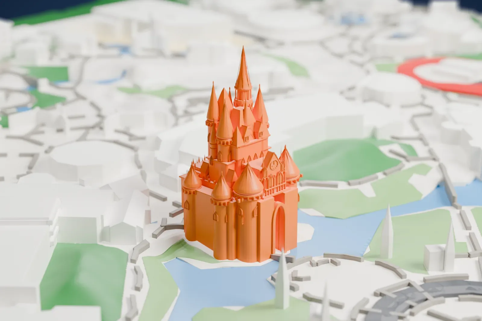 A white 3D print of Cinderella Castle, a cluster of pointed spires and round turrets, with water, curving paths and lawns around its base.