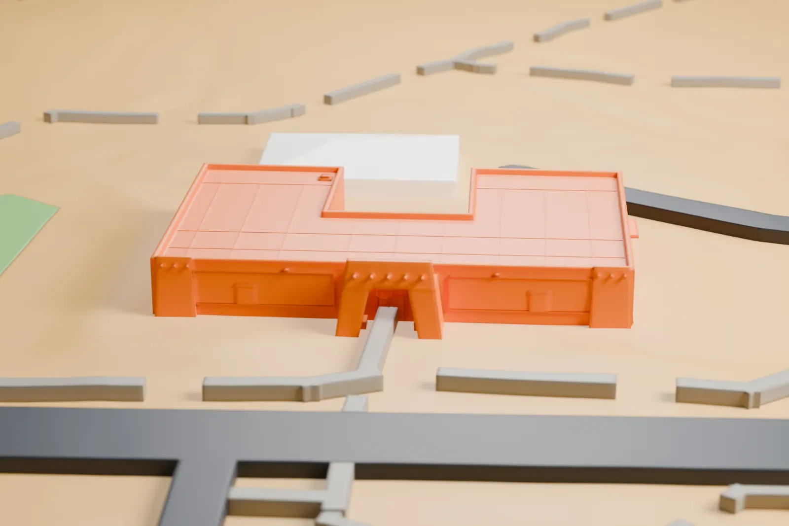 A white 3D print of the Clark County Museum, a small low building on a wide open site, with streets and houses around it.