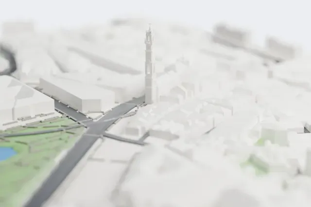 A white 3D print of the Clérigos Church, a Baroque church with a tall, slender bell tower, surrounded by closely packed pitched-roof buildings, with a park and pond nearby.