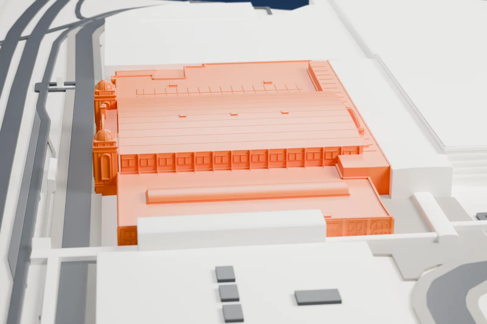 A white 3D print of the Coca-Cola Coliseum with its twin brick towers and long low arena roof, set among the buildings of Exhibition Place.