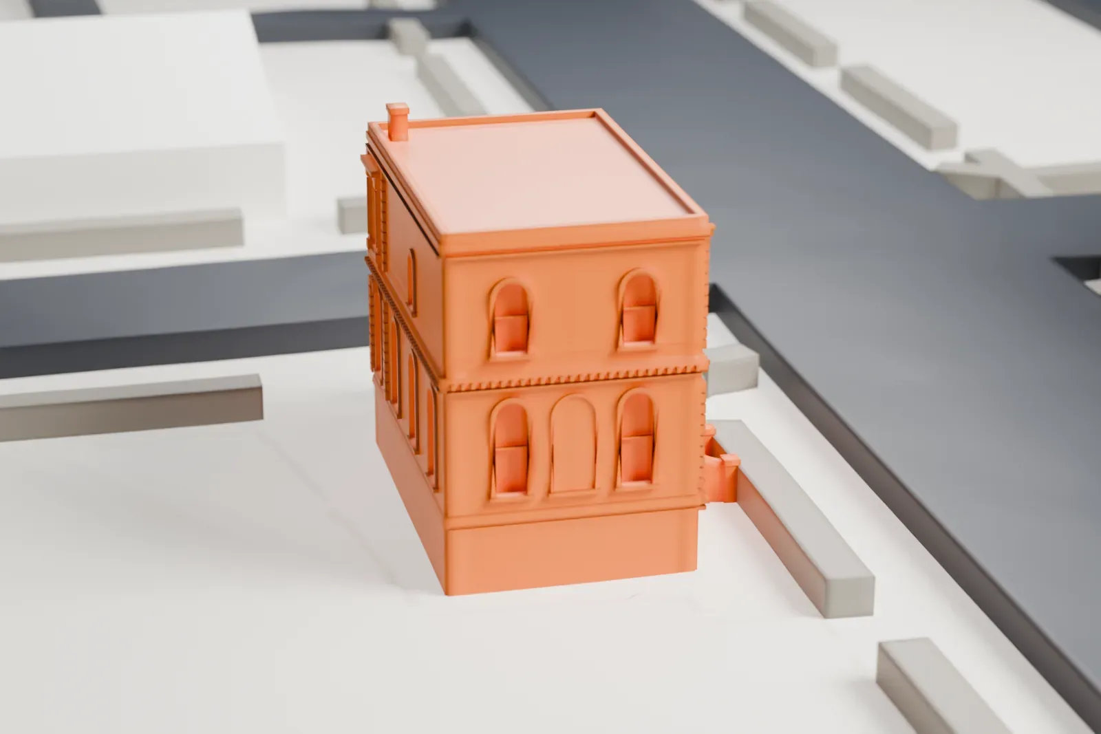 A white 3D print of the Coignet Stone Company Building, a small two-story building with an ornate facade and curved entrance stairs, beside a street corner.