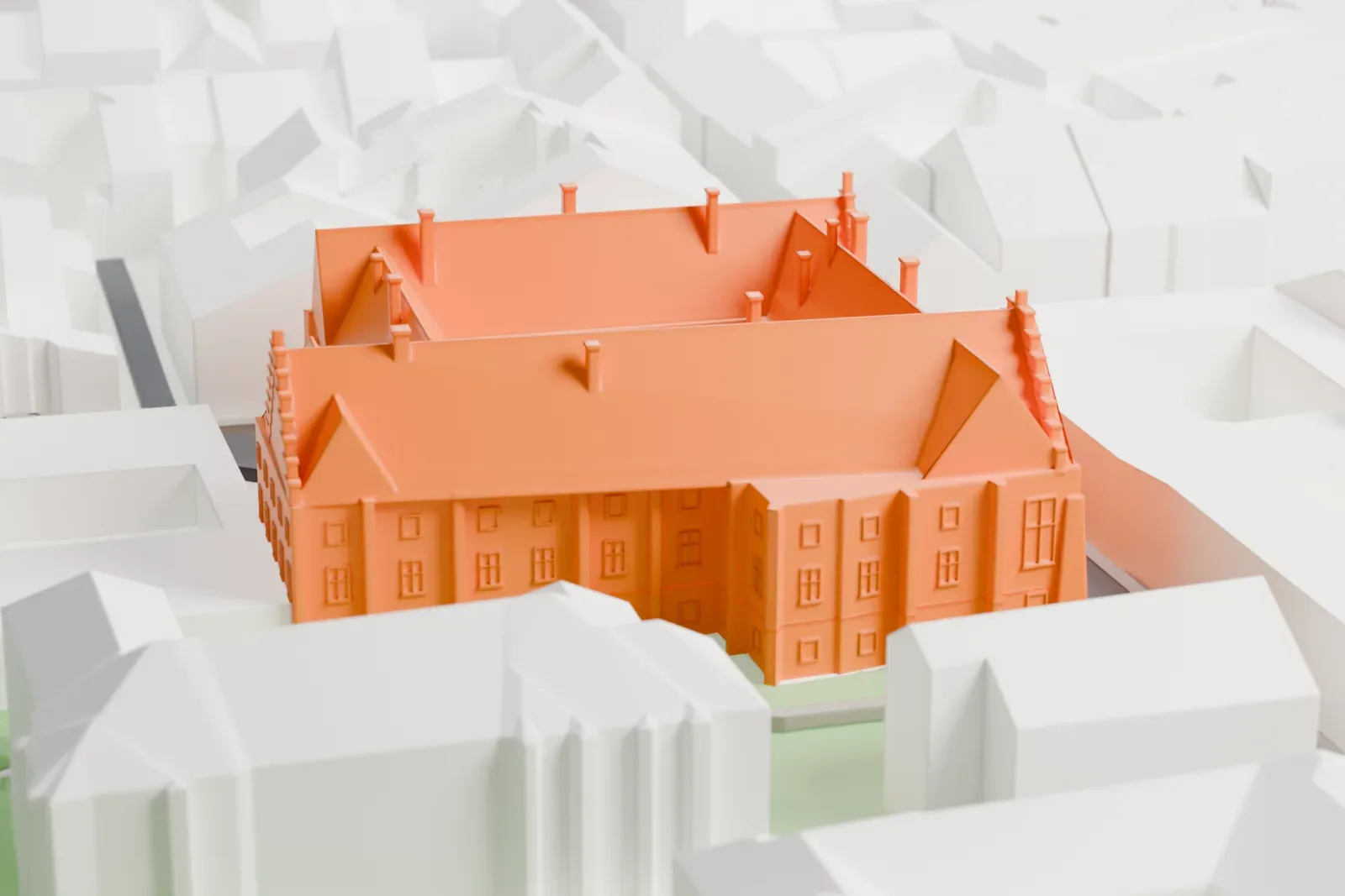 A white 3D print of Collegium Maius with the surrounding streets and buildings of Kraków's Old Town.