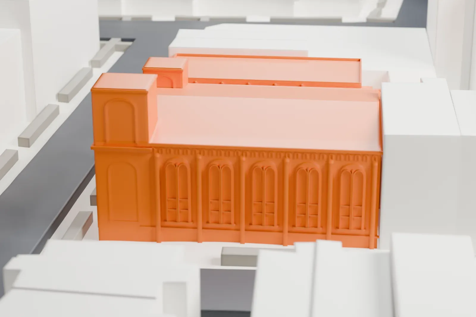 A white 3D print of the Kane Street Synagogue, a large hall with two square towers and rows of round-arched windows, among low apartment buildings.