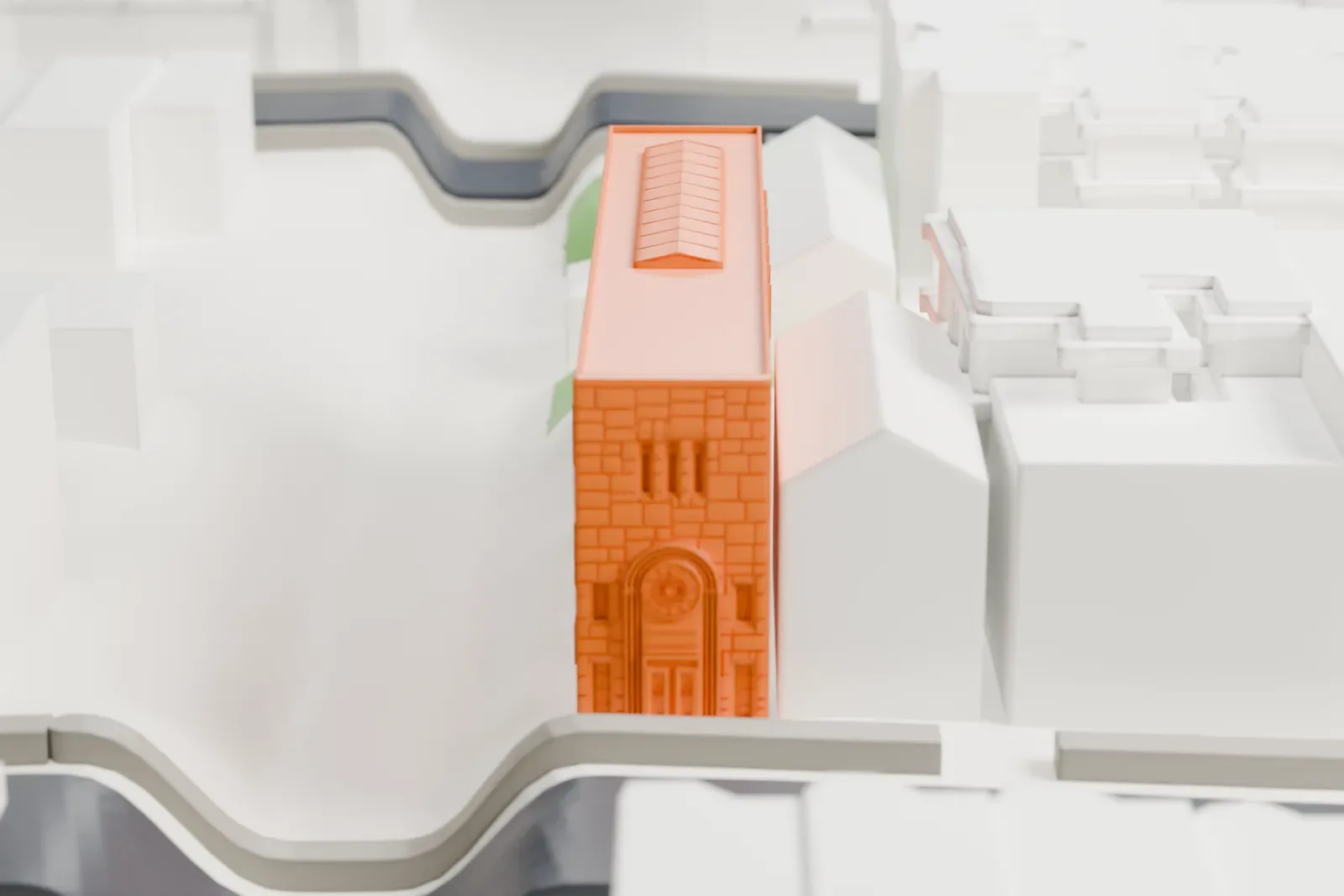 A white 3D print of Congregation Kol Israel, a long rectangular building with arched windows and a roof skylight, among neighboring buildings with a sunken subway cut beside it.