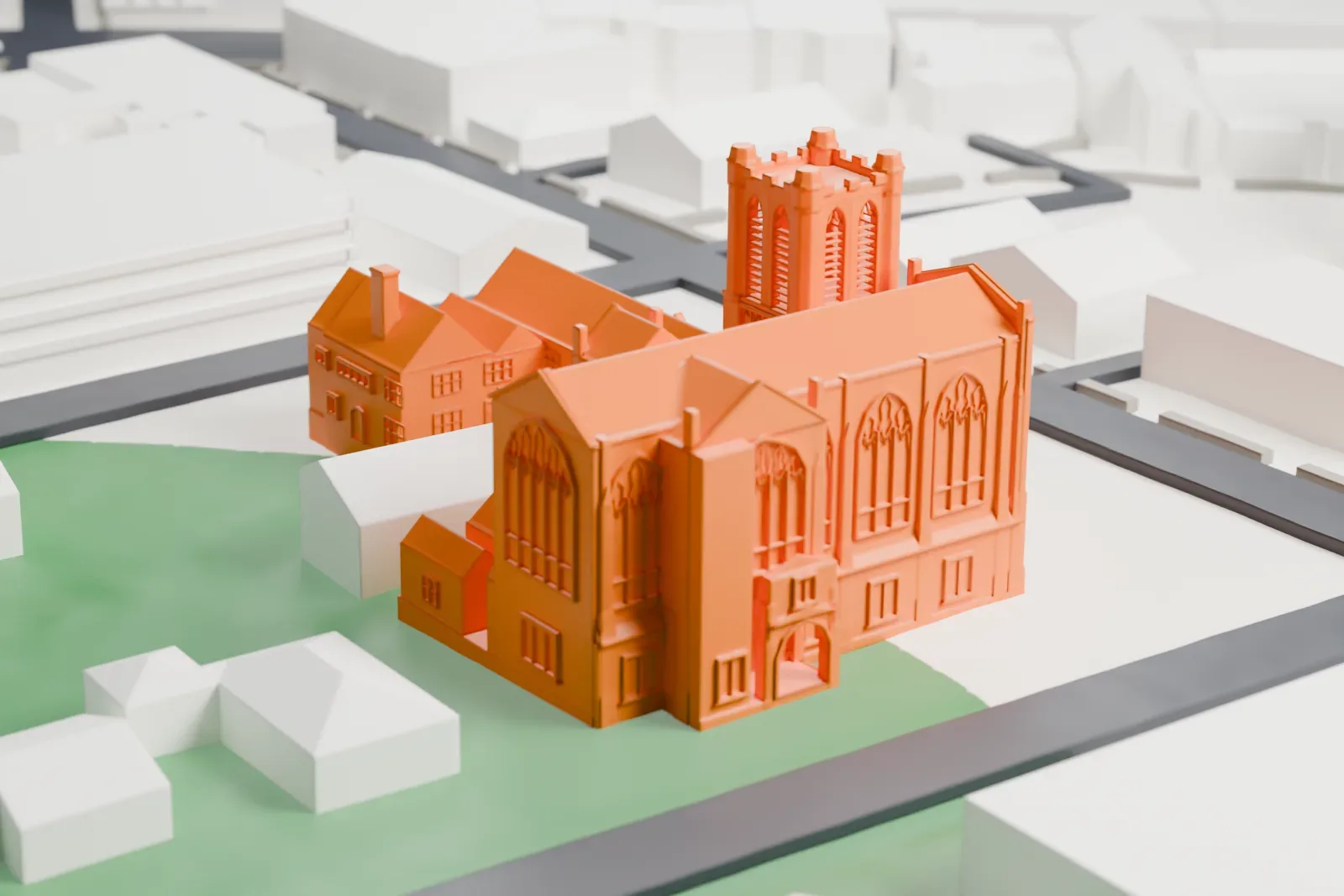 A white 3D print of the Congregational Church in Montclair, a Gothic-style church with a square tower, tall pointed windows and low wings, among lawns, houses and streets.