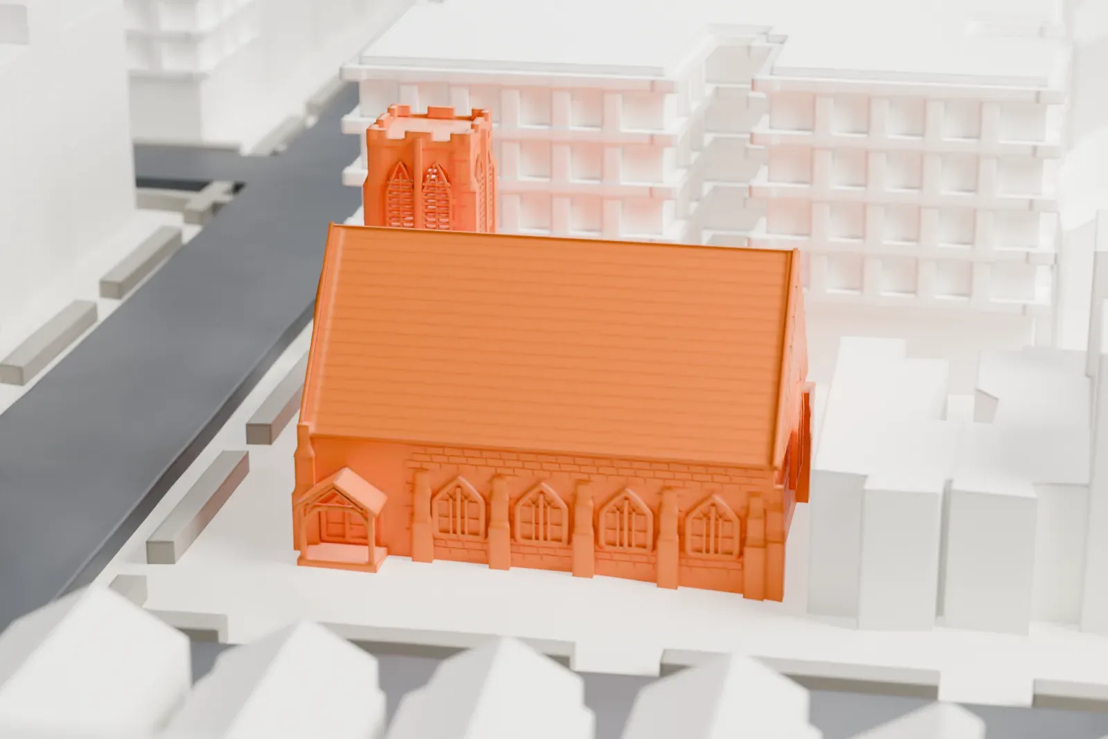 A white 3D print of a church with a steeply pitched gabled roof and a square bell tower, among taller buildings and streets.