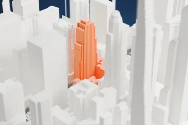 A white 3D print of the Conrad New York Midtown model in New York, with the streets around it.