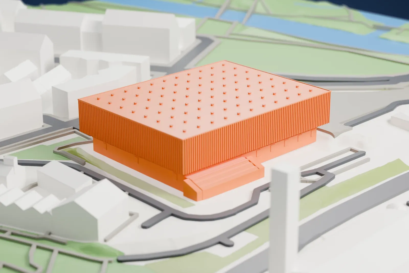A white 3D print of the Copper Box Arena, a large rectangular hall, set on its ground among the surrounding park and buildings.