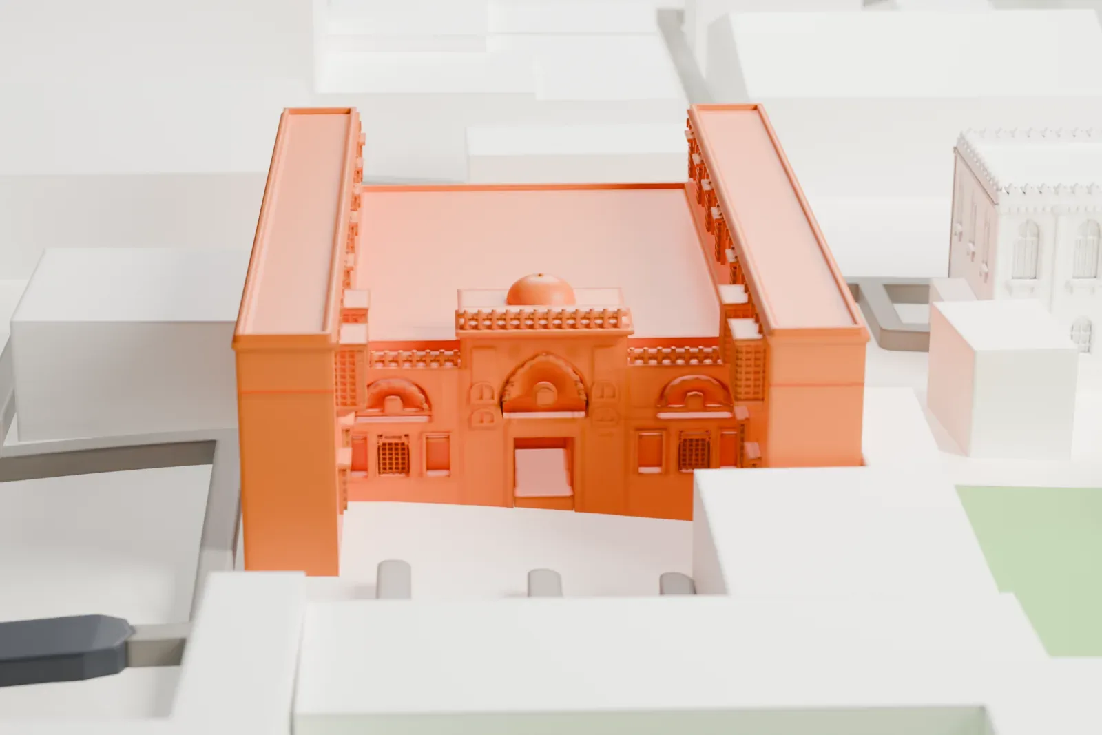 A white 3D print of the Coptic Museum, a low building with a detailed façade, among the surrounding streets and buildings of Coptic Cairo.