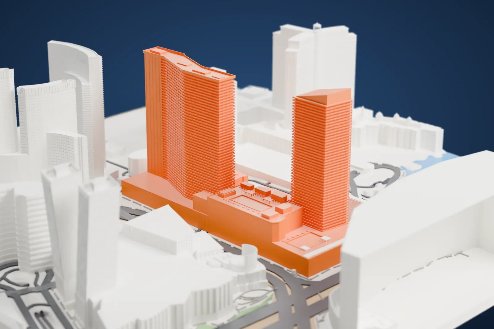 A white 3D print of the Cosmopolitan's two hotel towers rising from a lower base, with neighboring towers, wide roads and a patch of water around them.