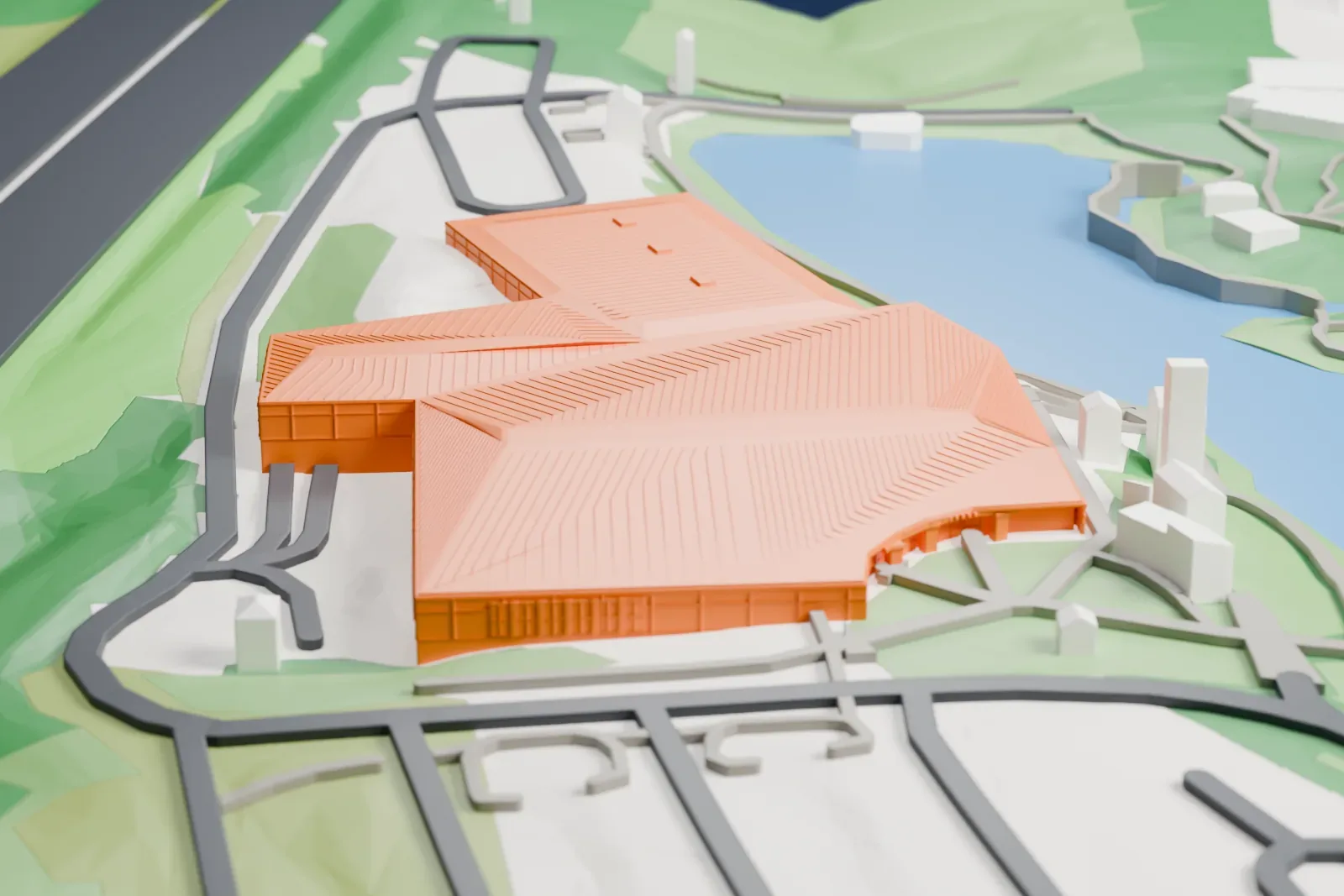 A white 3D print of the Creation Museum, a low building with a broad roof, standing among roads and nearby buildings.