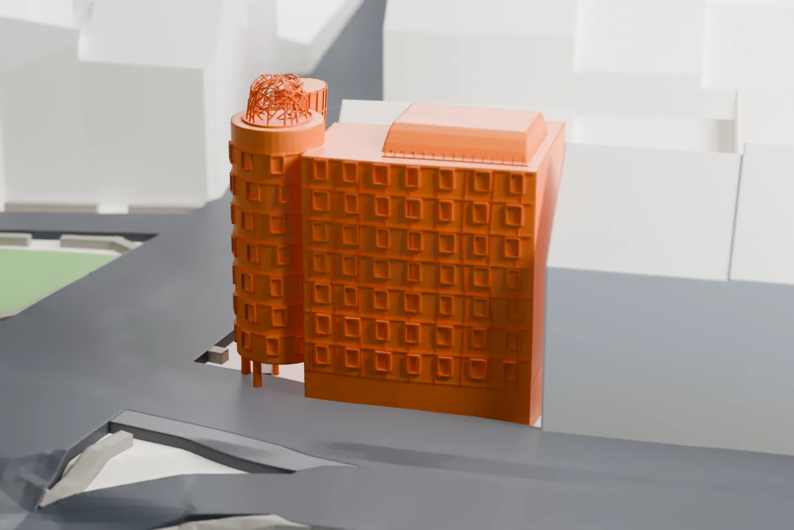 A white 3D print of the Dancing House, two curving towers with a twisted metal web on top, beside a river and a wide road with neighboring buildings around it.