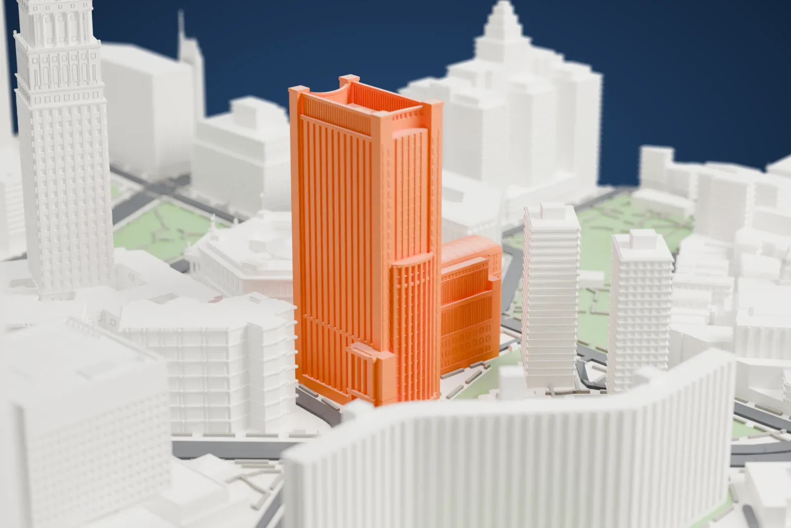 A white 3D print of the Daniel Patrick Moynihan United States Courthouse, a tall ribbed tower with a lower curved-roof block, among civic buildings, plazas and green patches.