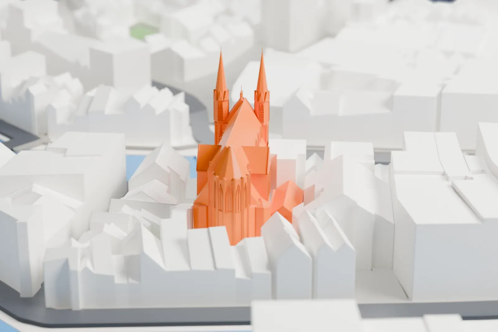 A white 3D print of De Krijtberg, a tall Neo-Gothic church with two pointed towers, standing among the surrounding streets and buildings of Amsterdam.