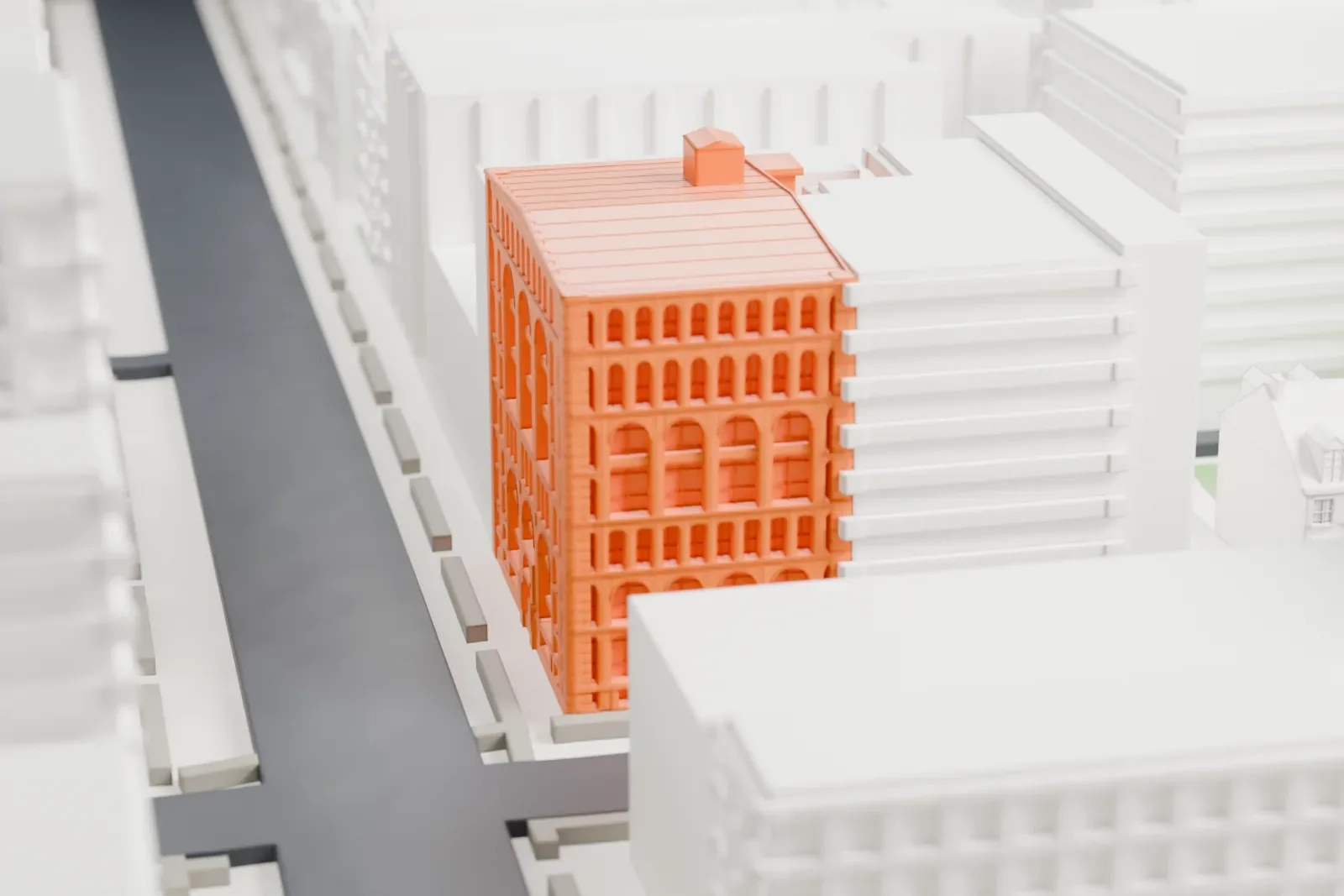 A white 3D print of the De Vinne Press Building, a block with arched windows and a rooftop box, sitting among neighboring blocks.