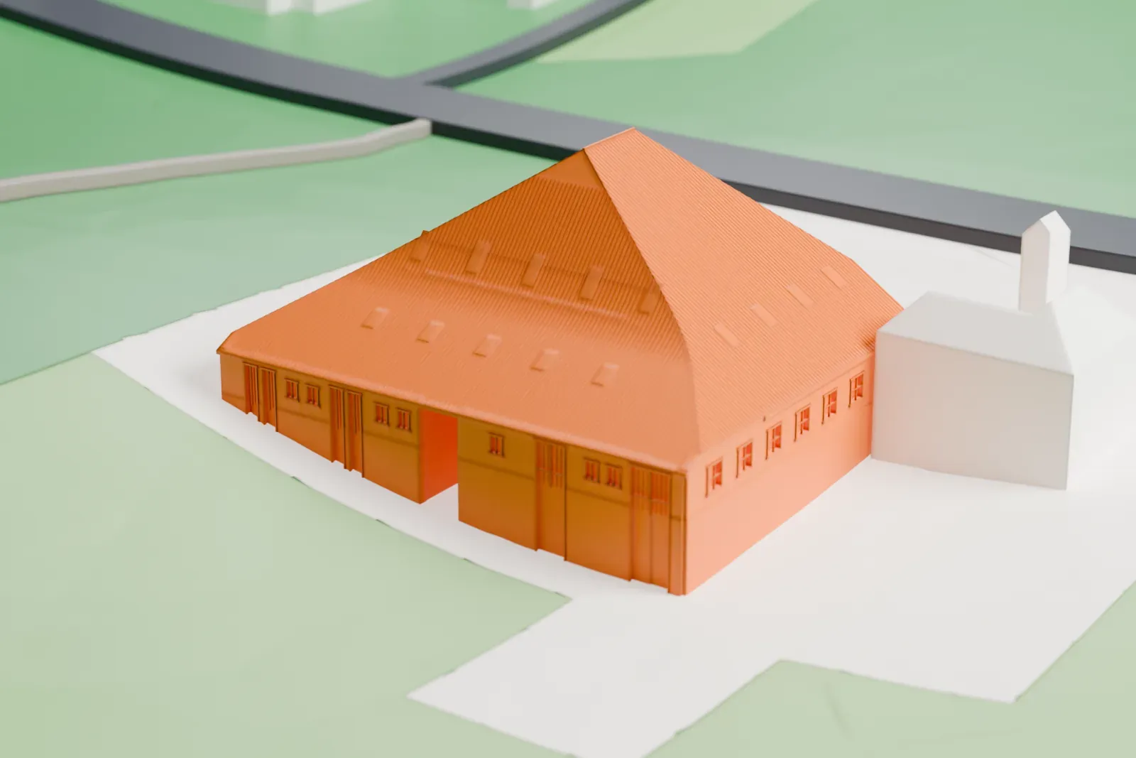 A white 3D print of the Deelen Adelaerthoeve Hangar 11, a broad hangar under one huge hipped roof, with a wide open entrance at one end and surrounding buildings.
