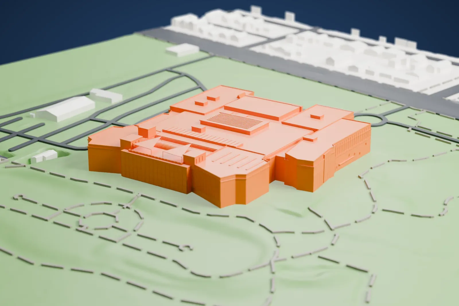 A white 3D print of the Denver Museum of Nature & Science, a wide cluster of low blocks with flat roofs, on a green site with curving paths and roads.