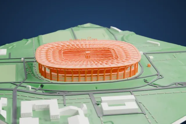 A white 3D print of the Deutsche Bank Park model in Frankfurt, with the streets around it.