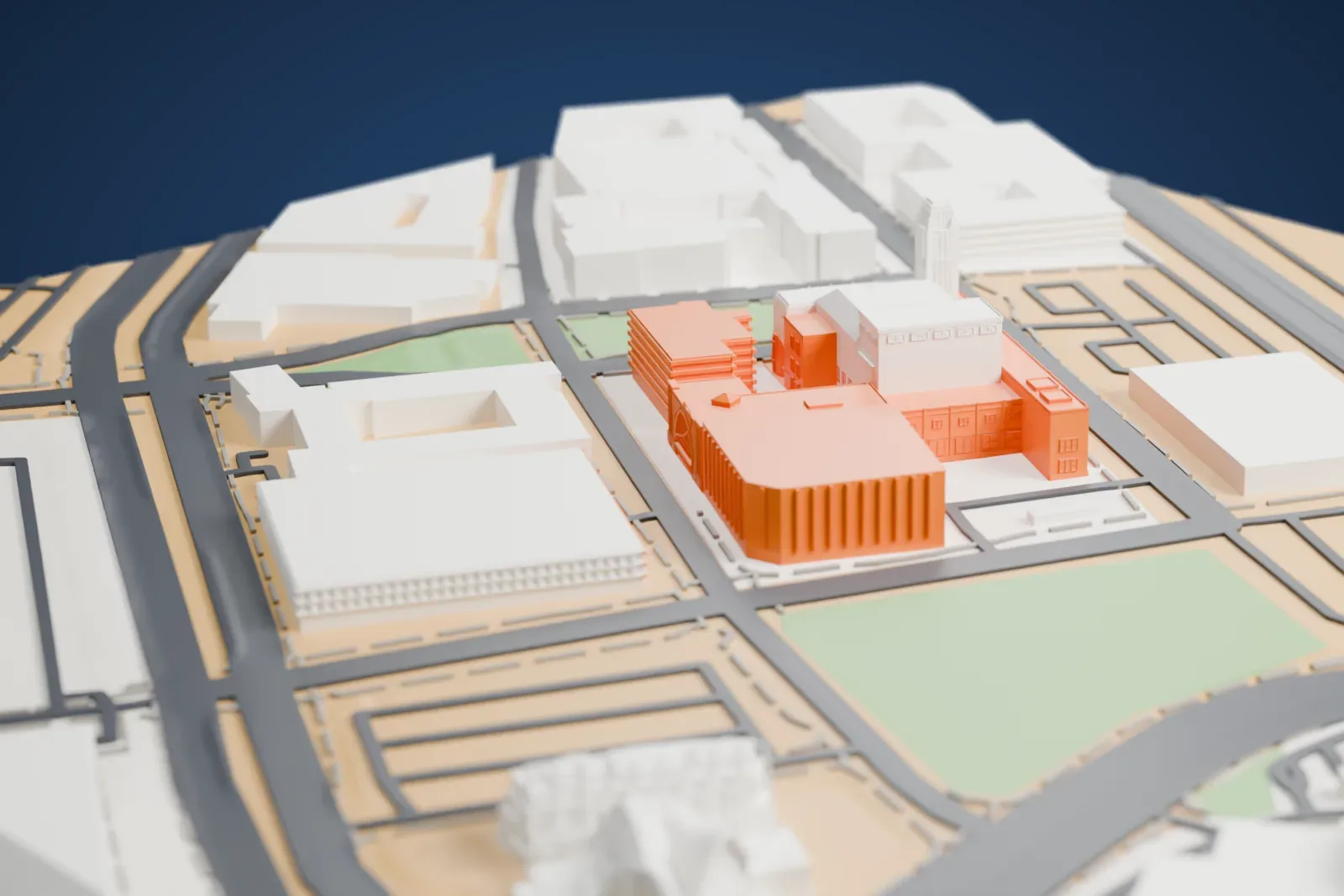 A white 3D print of Discovery Children's Museum, a boxy building with a big arch across its front and a small pyramid-roofed piece on top, wedged between larger buildings.