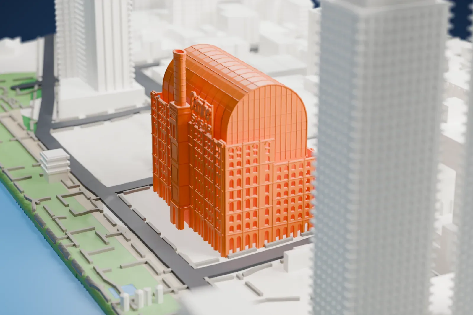 A white 3D print of the Domino Sugar Refinery, a tall block with a curved barrel roof and a slim chimney, beside the water with a green waterfront park.