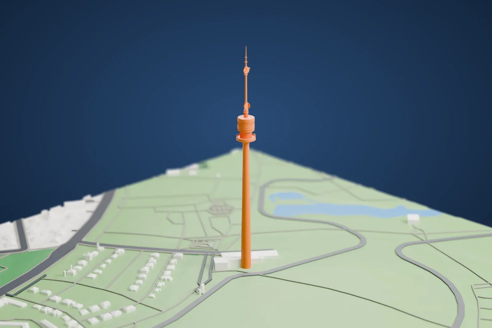 A white 3D print of the Donauturm, a tall tower rising from the Donaupark in Vienna, with the surrounding park and buildings.