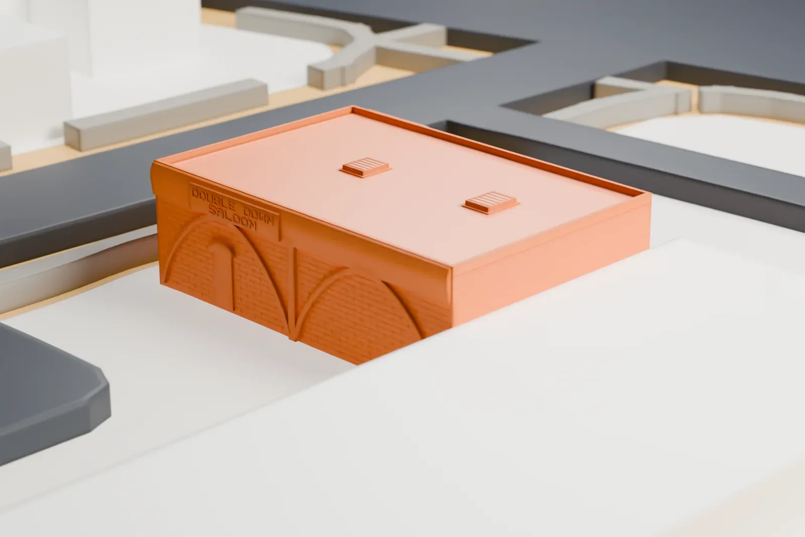 A white 3D print of the Double Down Saloon, a small flat-roofed bar with a lattice porch, standing beside a street with larger buildings and lots nearby.