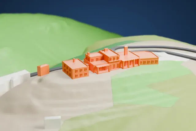 A white 3D print of the Douglas Mansion model in Jerome, with the streets around it.