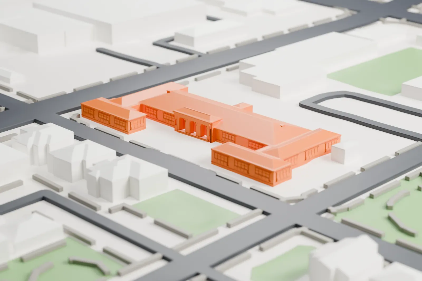 A white 3D print of Dunbar School, a low school building with a pitched roof and projecting wings, surrounded by streets, grass and small houses.