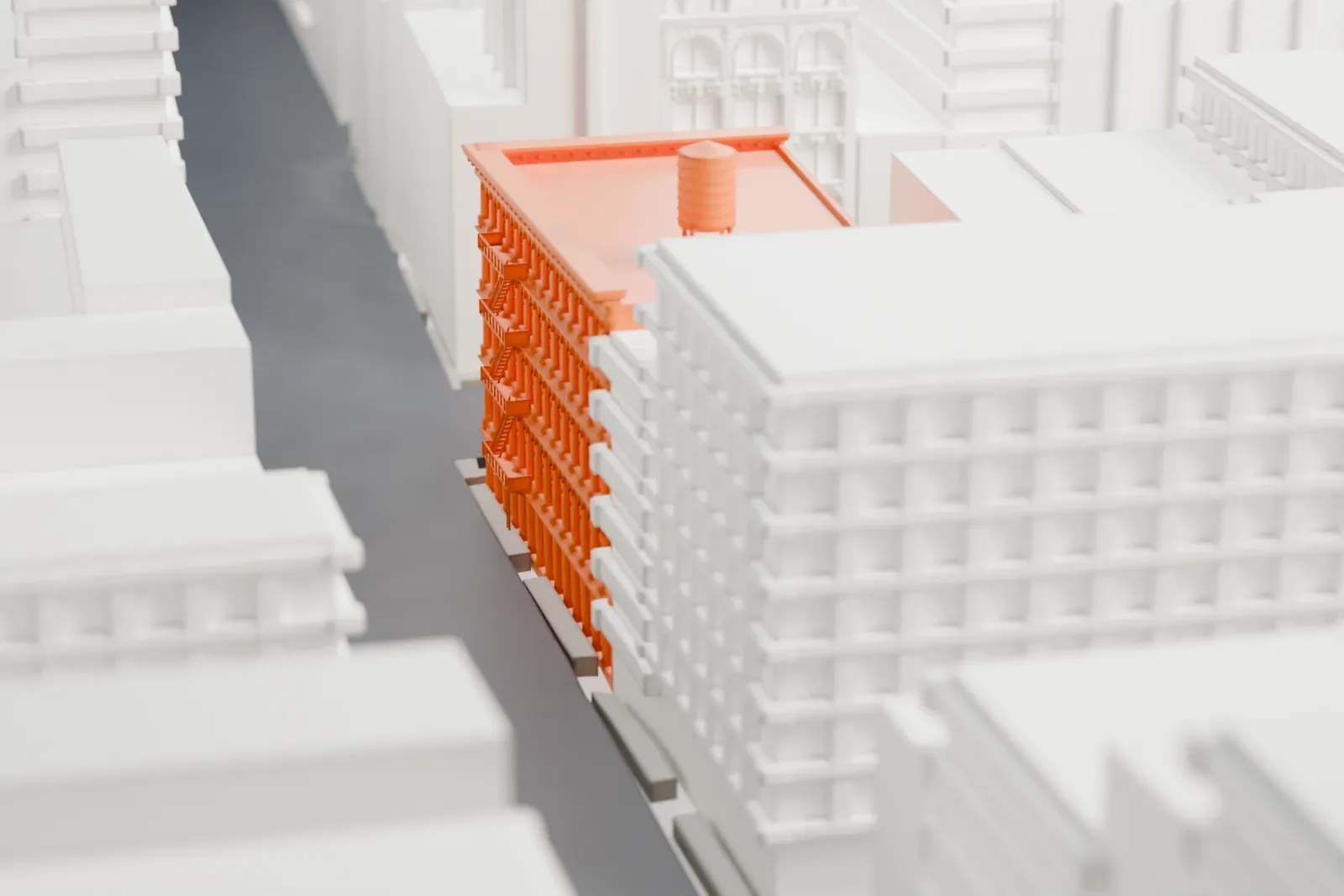 A white 3D print of the E. V. Haughwout Building, a boxy loft building with a rooftop water tank, surrounded by neighboring buildings.