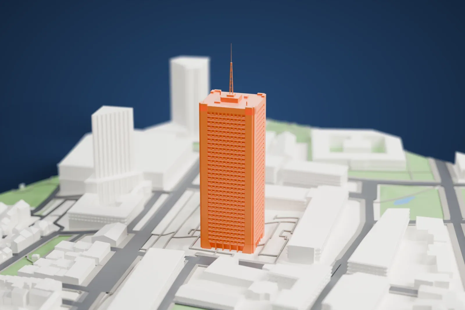A white 3D print of the Édifice Marie-Guyart, a tall tower rising among the surrounding streets and buildings.