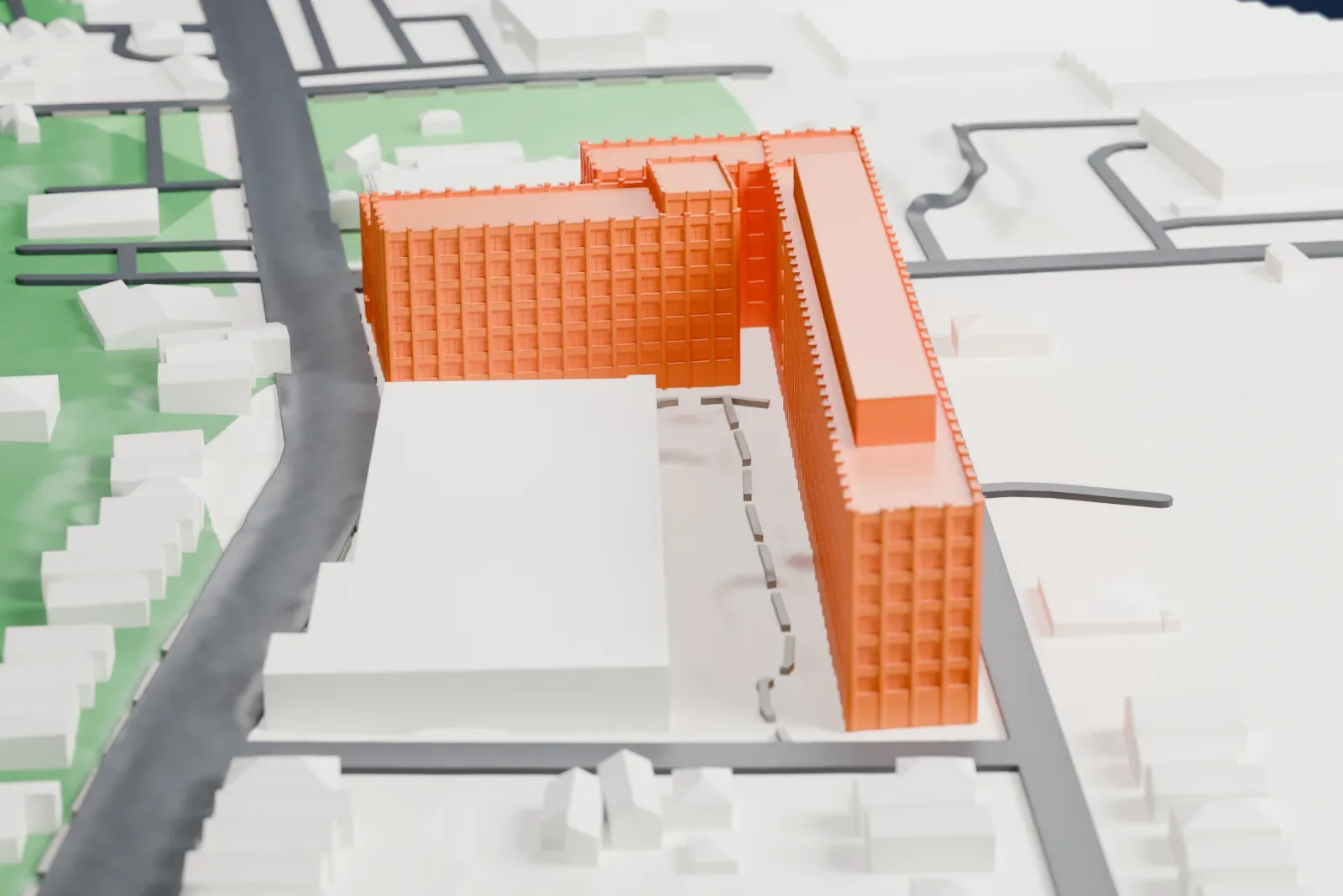 A white 3D print of the Edison Storage Battery Company Building, a long factory with several wings and rows of windows, beside streets and small houses.