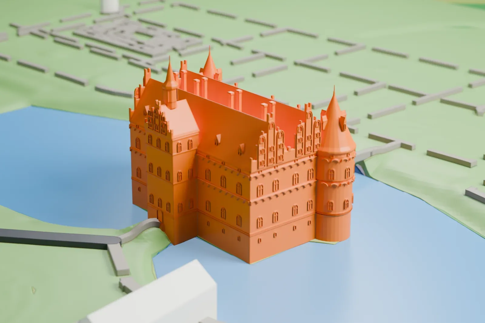 A white 3D print of Egeskov Castle, a castle with round corner towers and pointed gables, standing in a lake with lawns, paths and gardens around it.