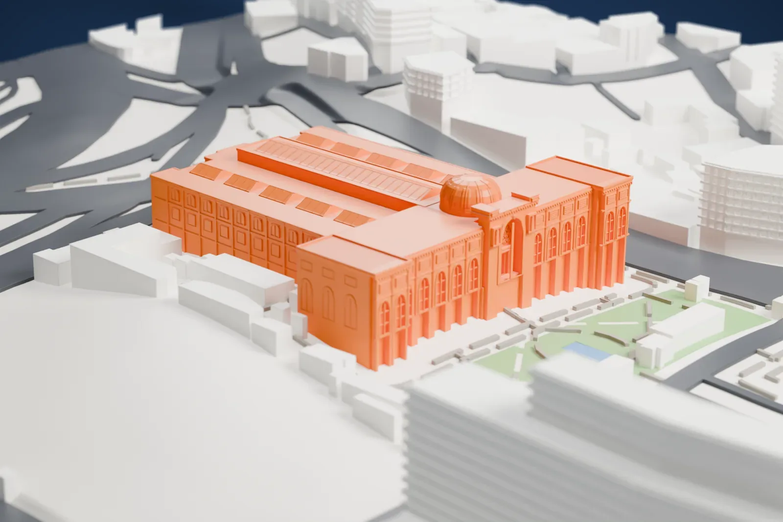 A white 3D print of the Egyptian Museum, a wide, low building with a central dome, arched windows and rows of slanted roof panels, surrounded by busy roads, a small garden and nearby buildings.