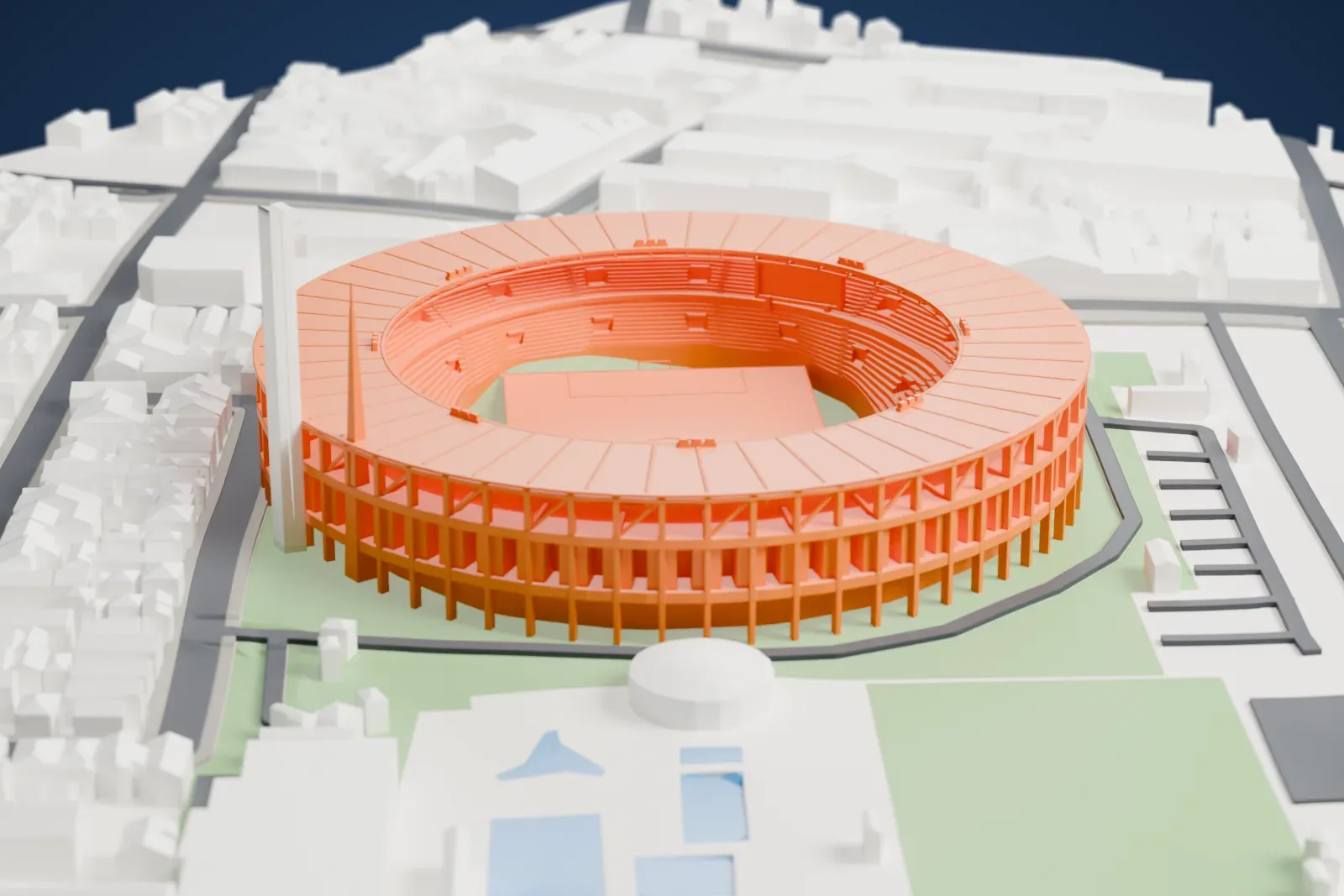A white 3D print of El Cilindro, a round stadium with a ring-shaped roof, a tall tapered tower and open concrete bays, among surrounding city buildings.