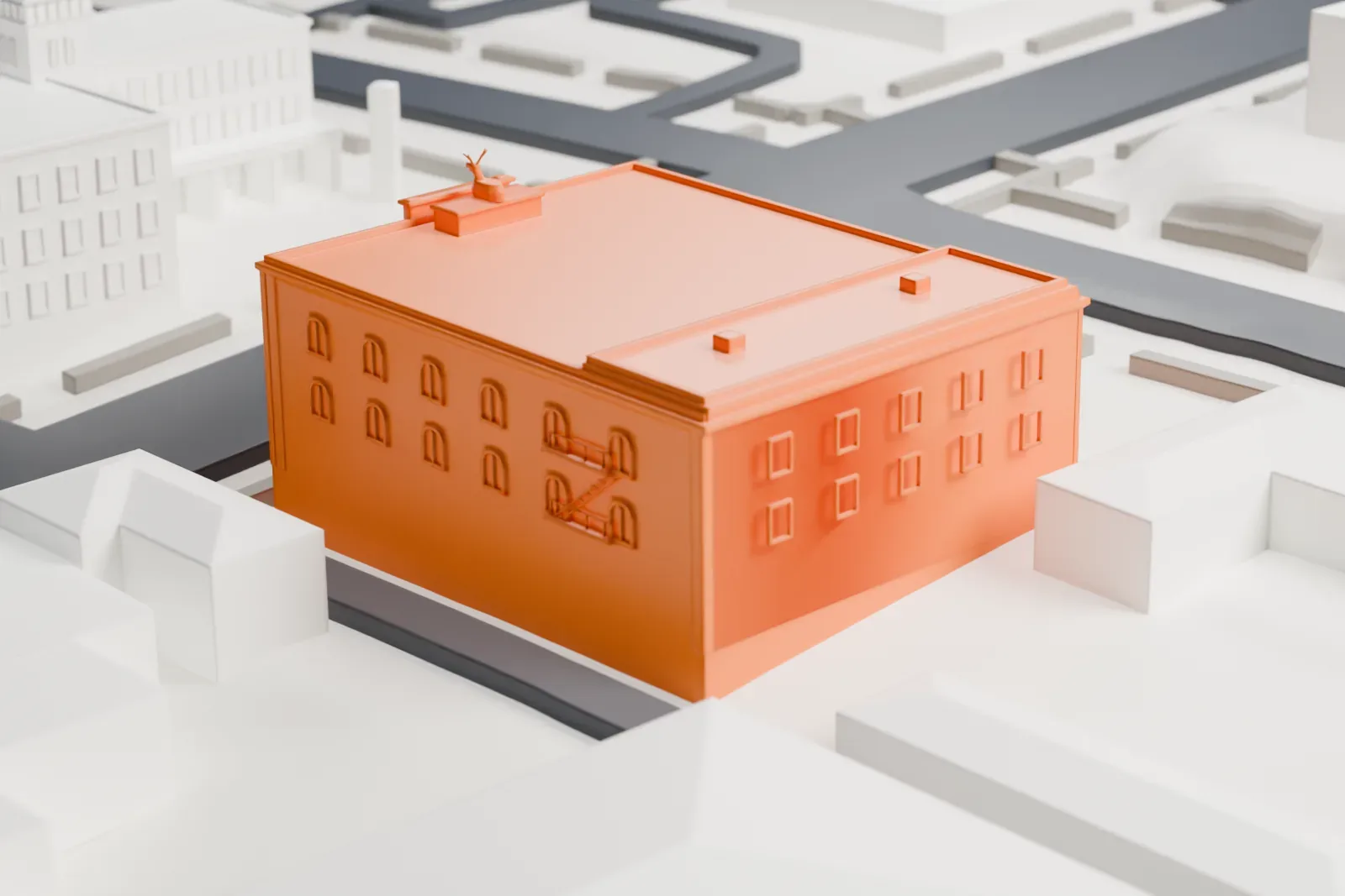 A white 3D print of the Elks Theatre, a boxy building with a broad roof, small balconies on its front wall and a tiny elk figure on the roof, standing among low buildings and streets.