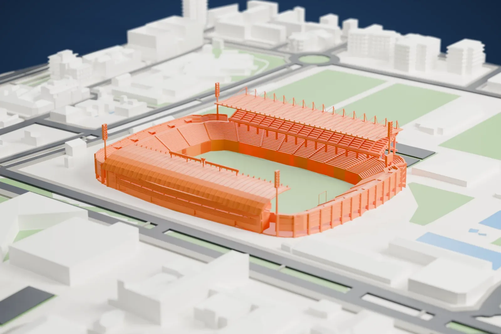 A white 3D print of the Estadio Carlos Belmonte, an open football bowl with two roofed stands, curved open ends and tall floodlight masts, among surrounding city buildings.