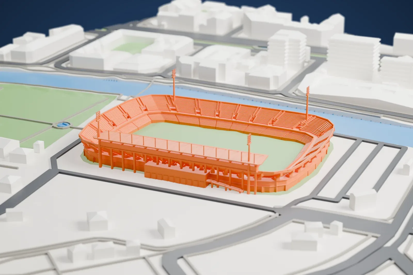 A white 3D print of Estadio Cartagonova, a two-tier football stadium with a green pitch and tall floodlight masts, beside a river and surrounding streets.