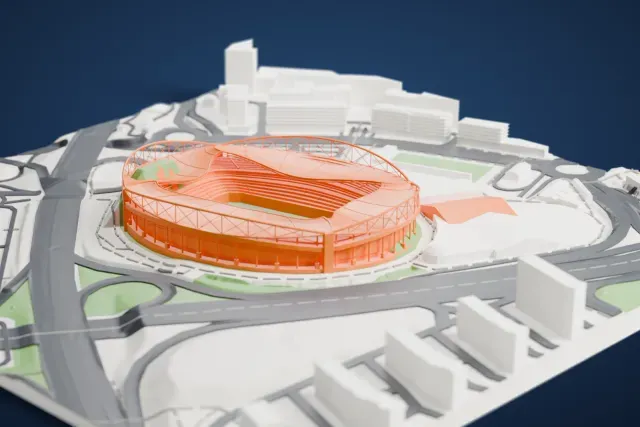 A white 3D print of Estádio da Luz, an oval stadium with a sweeping roof and steel arches, surrounded by wide roads, roundabouts and nearby buildings.