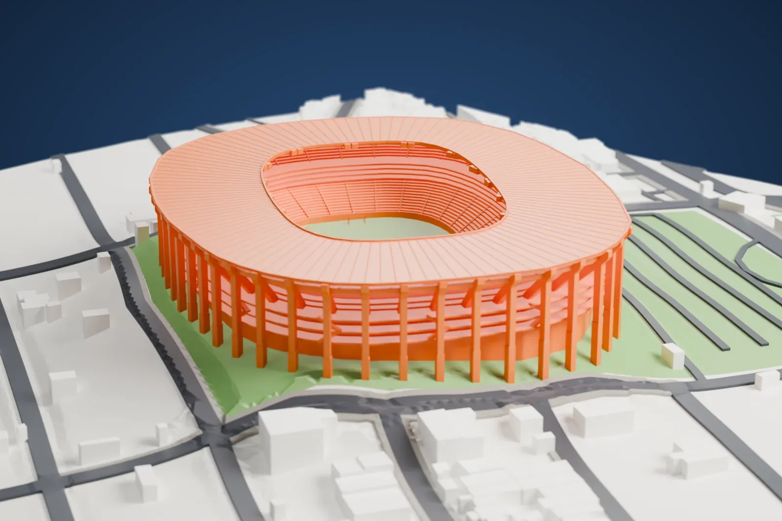 A white 3D print of Estadio Jalisco, a low oval stadium with an open center, among surrounding streets and buildings.