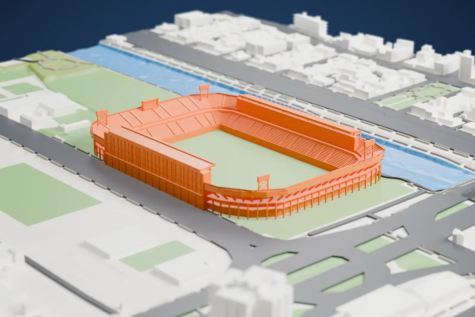 A white 3D print of the Estadio La Rosaleda, a two-tier bowl with a roofed stand on one side, a row of leaning fins on the other and open ends, on a base of surrounding streets and buildings.