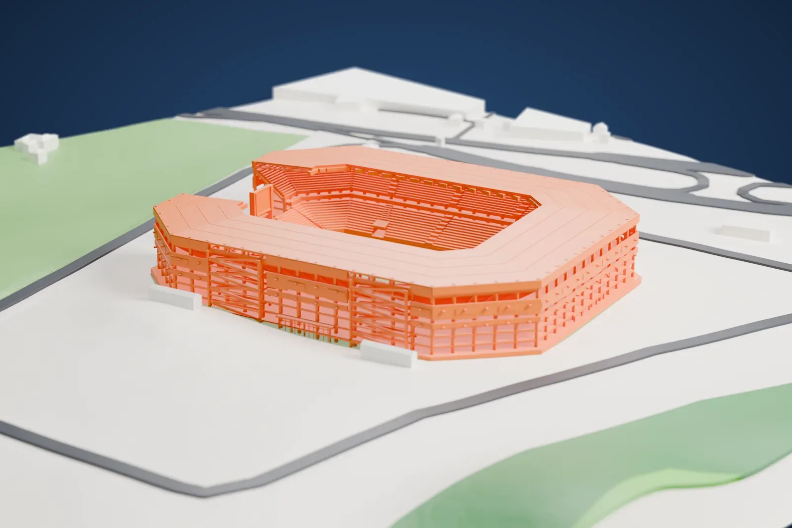 A white 3D print of Estadio Metropolitano de Cabudare, a stadium with a wide roof ring close around the pitch, among the surrounding roads and open ground.