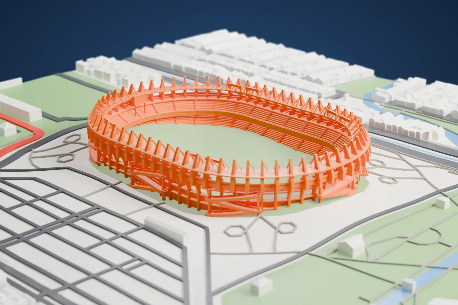 A white 3D print of the Estadio Metropolitano Roberto Meléndez, an open oval bowl ringed by tall inward-leaning blades, among the surrounding streets and buildings of Barranquilla.