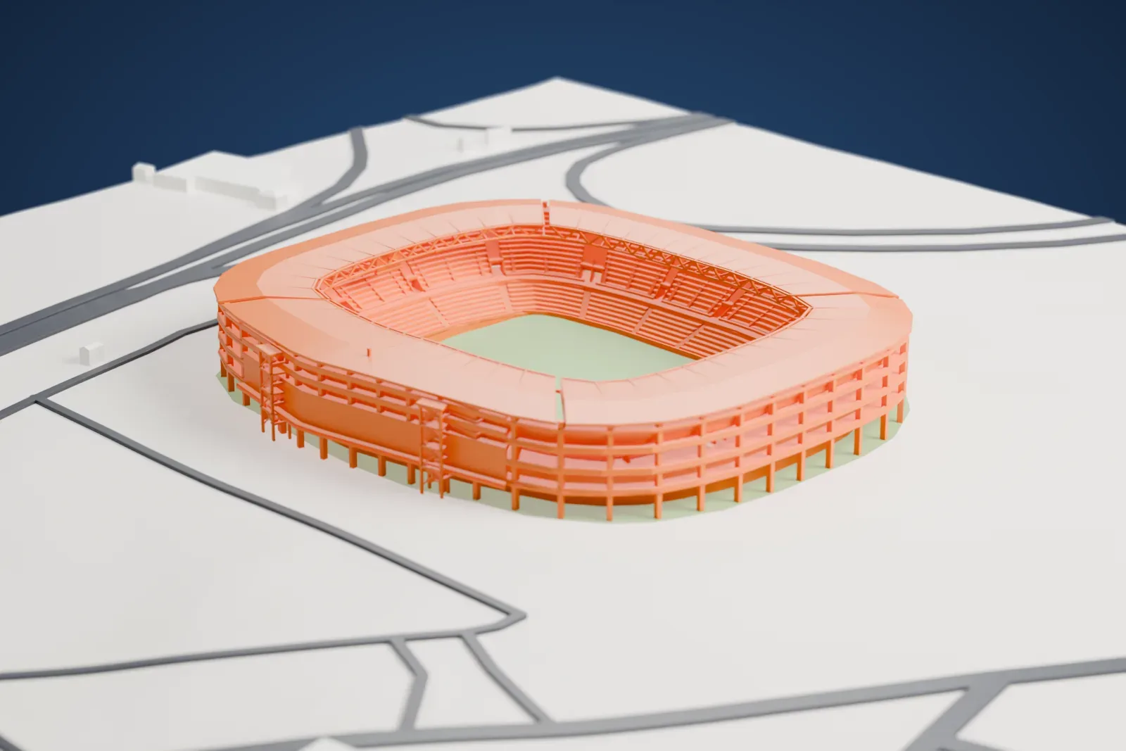 A white 3D print of Estadio Monumental de Maturín, an oval stadium with an open column frame and a wide roof ring, on flat ground with roads and a few small buildings.