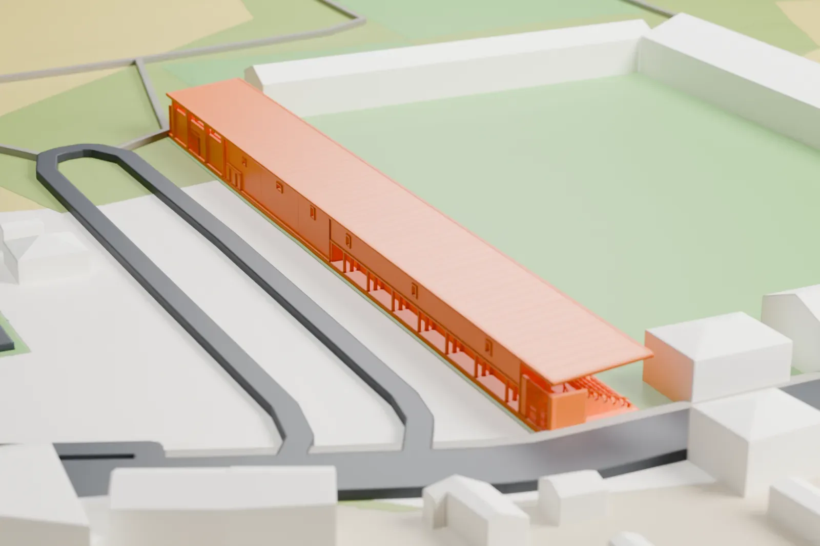 A white 3D print of Estadio Municipal de Anduva, a long covered grandstand with a thin roof beside a green pitch, among surrounding streets and houses.