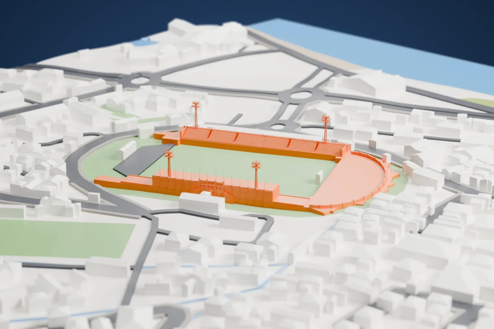 A white 3D print of Estádio Nacional 12 de Julho, a stadium with a roofed stand and floodlight towers around a pitch, among the surrounding streets and buildings.