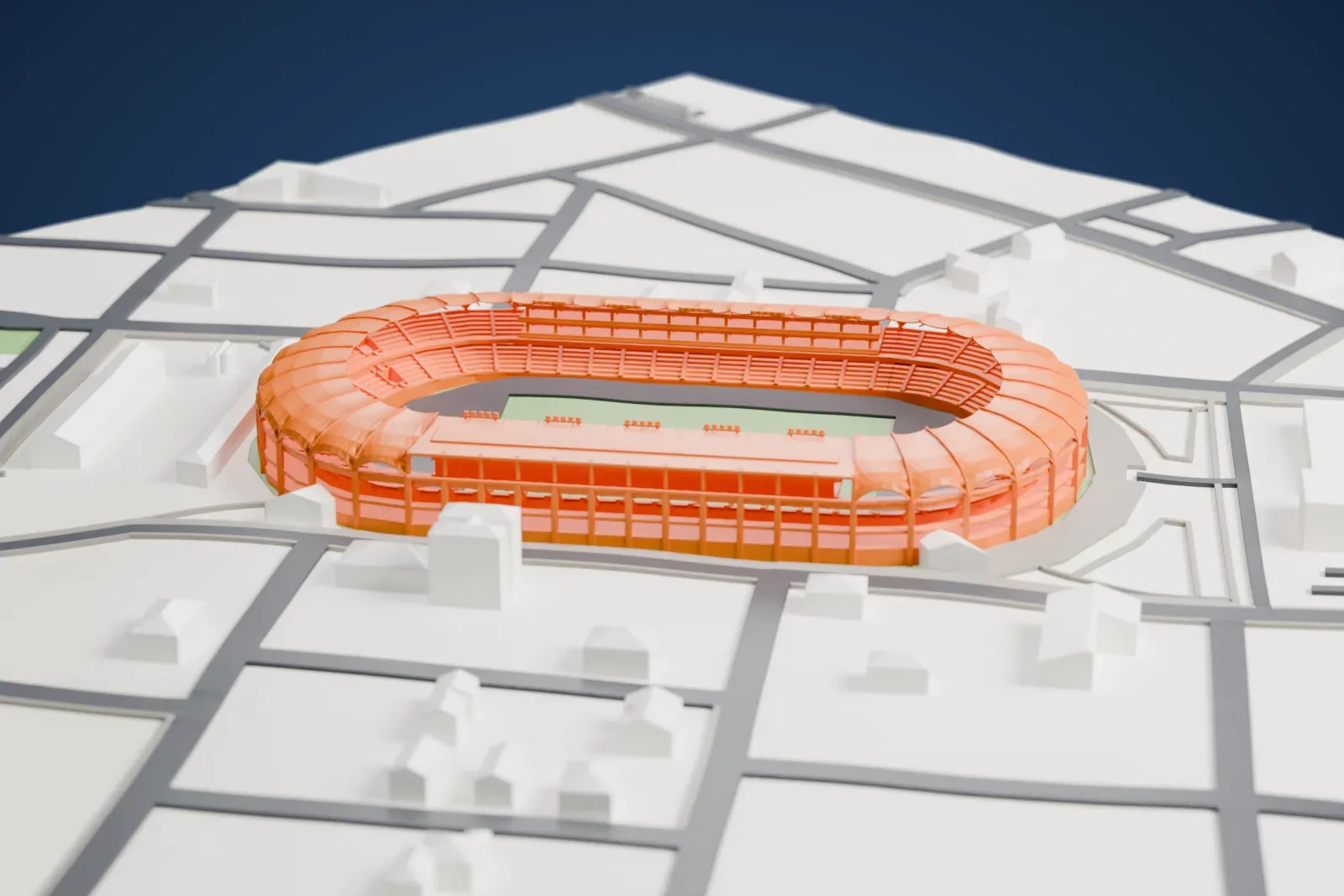 A white 3D print of the Estadio Olímpico Pascual Guerrero, an open oval bowl with a curved roof around three sides, among the surrounding city.